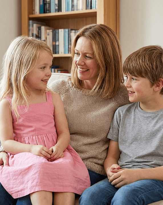 Sarah with her two kids reviewing a science subscription box